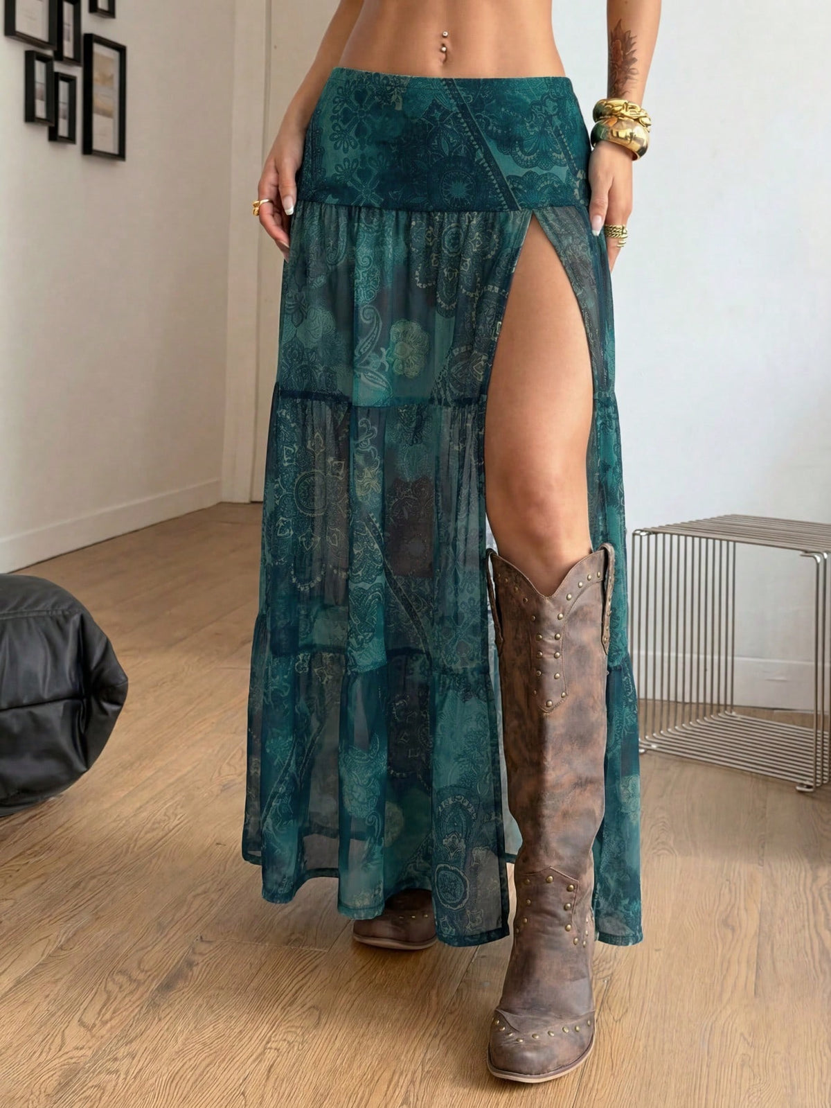 Women's low rise flared long skirt featuring an all-over print, split thigh accent, and textured semi-sheer fabric.