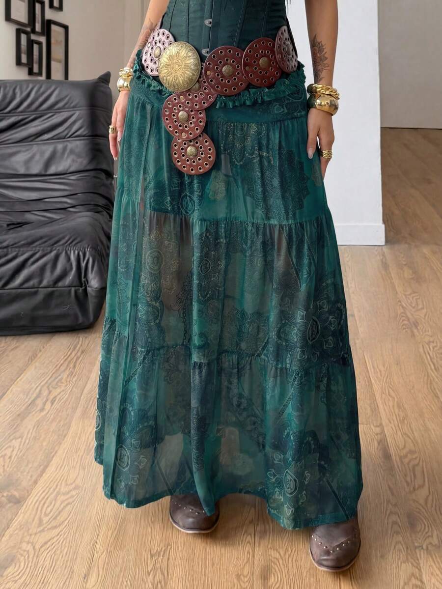Women's low rise flared long skirt featuring an all-over print, split thigh accent, and textured semi-sheer fabric.