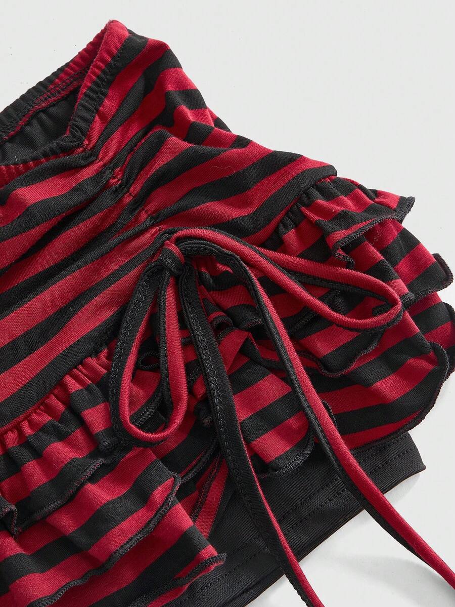 Women's black low-waist mini skirt with drawstring tie, ruched details, lace trim, layered ruffle hem, and asymmetric styling