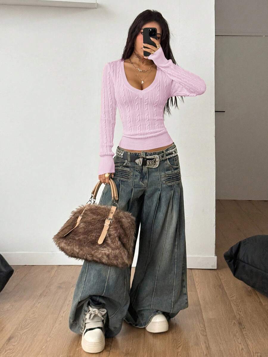 Women's slim fit cable-knit sweater with a V-neckline and long sleeves in solid green rib knit fabric.
