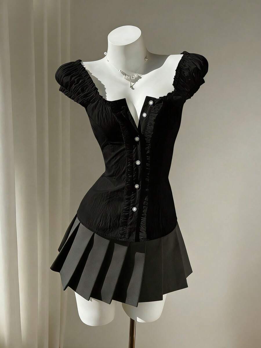 Women's black off-shoulder cap sleeve blouse with ruffled detailing and a tie-back design.