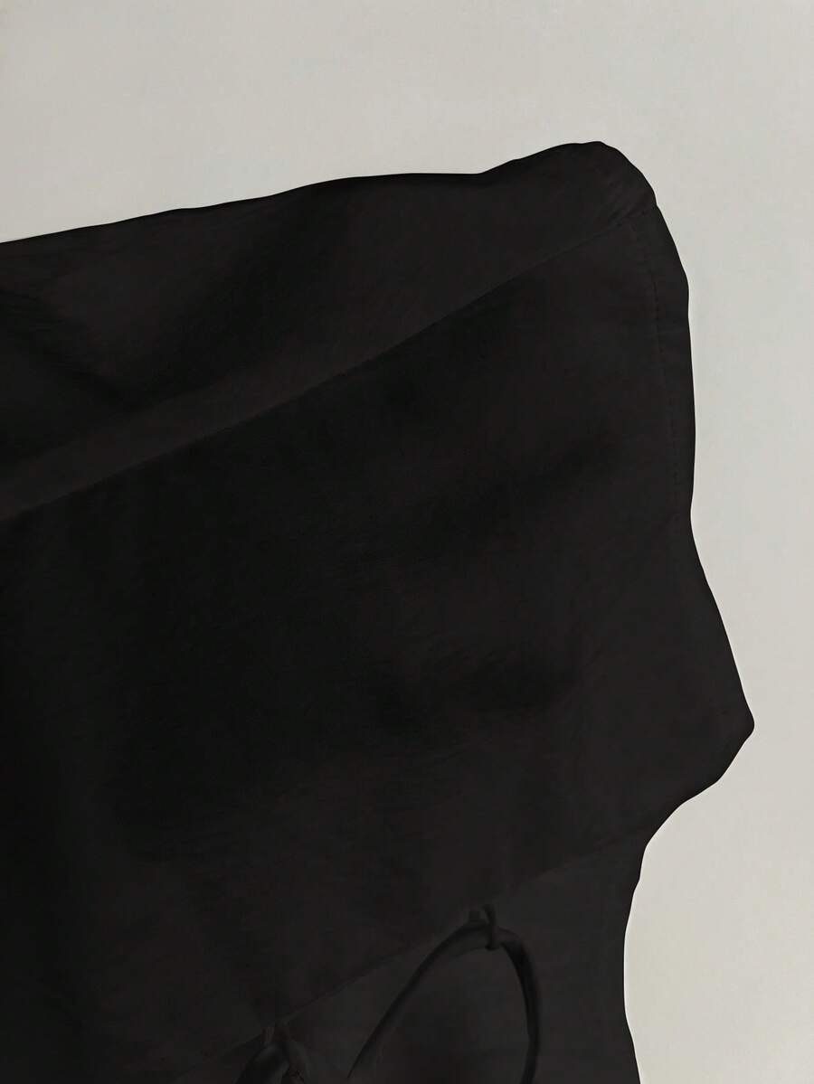 Women's black off-shoulder cap sleeve blouse with ruffled detailing and a tie-back design.