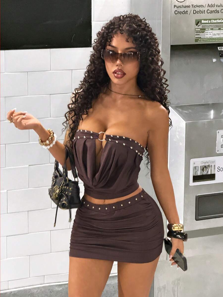 Women's Y2K two-piece set with a strapless bandeau crop top and matching studded mini skirt in a slim fit.