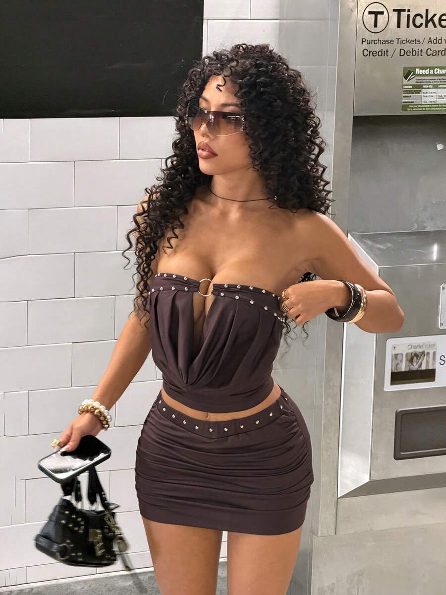 Women's Y2K two-piece set with a strapless bandeau crop top and matching studded mini skirt in a slim fit.