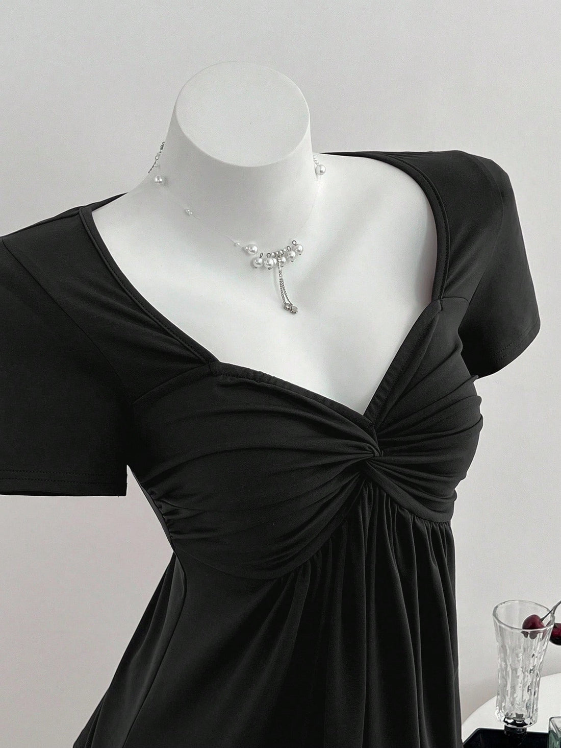 Women's short sleeve V-neck T-shirt featuring a front twist knot detail and slim fit.