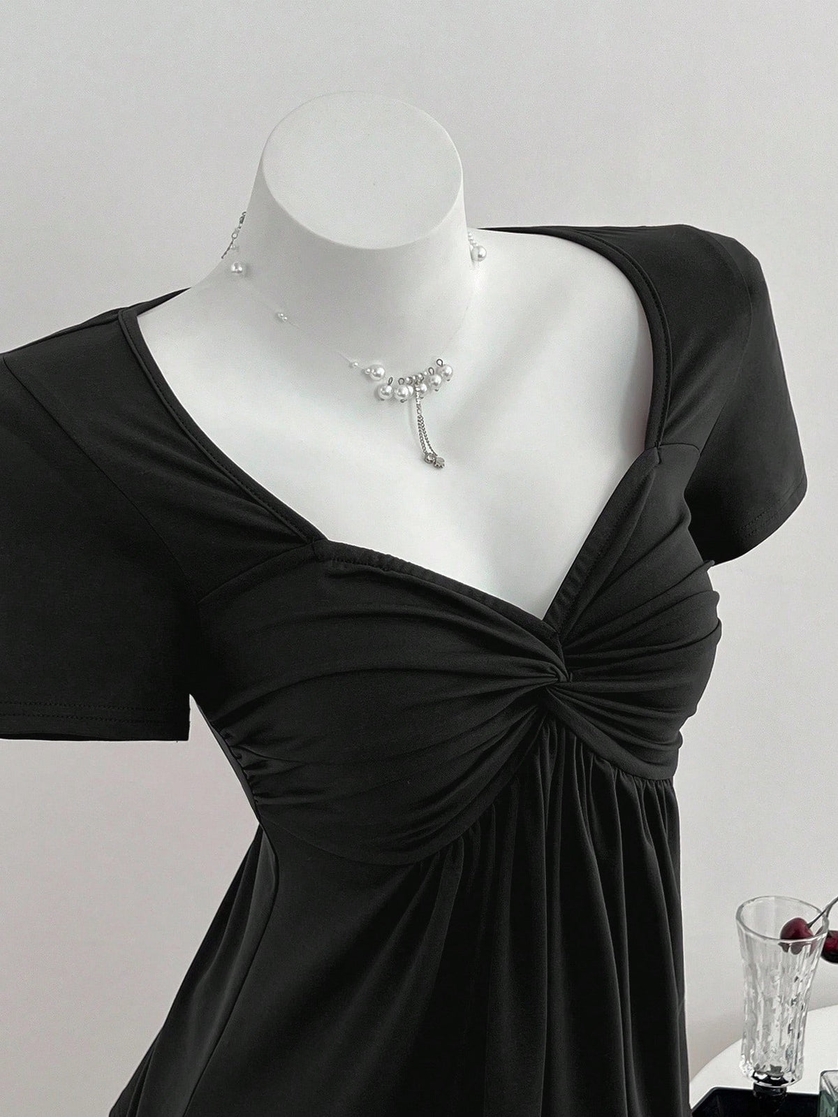 Women's short sleeve V-neck T-shirt featuring a front twist knot detail and slim fit.