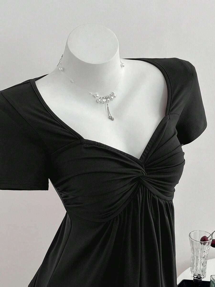 Women's short sleeve V-neck T-shirt featuring a front twist knot detail and slim fit.
