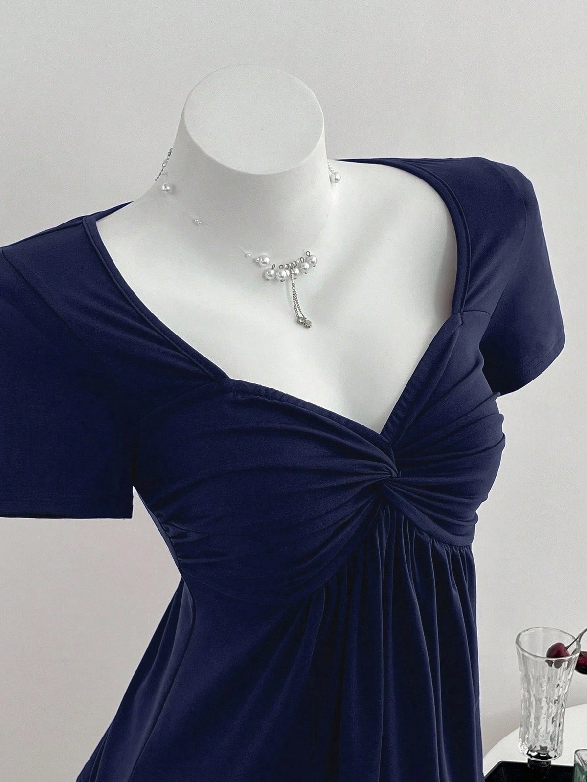 Women's short sleeve V-neck T-shirt featuring a front twist knot detail and slim fit.