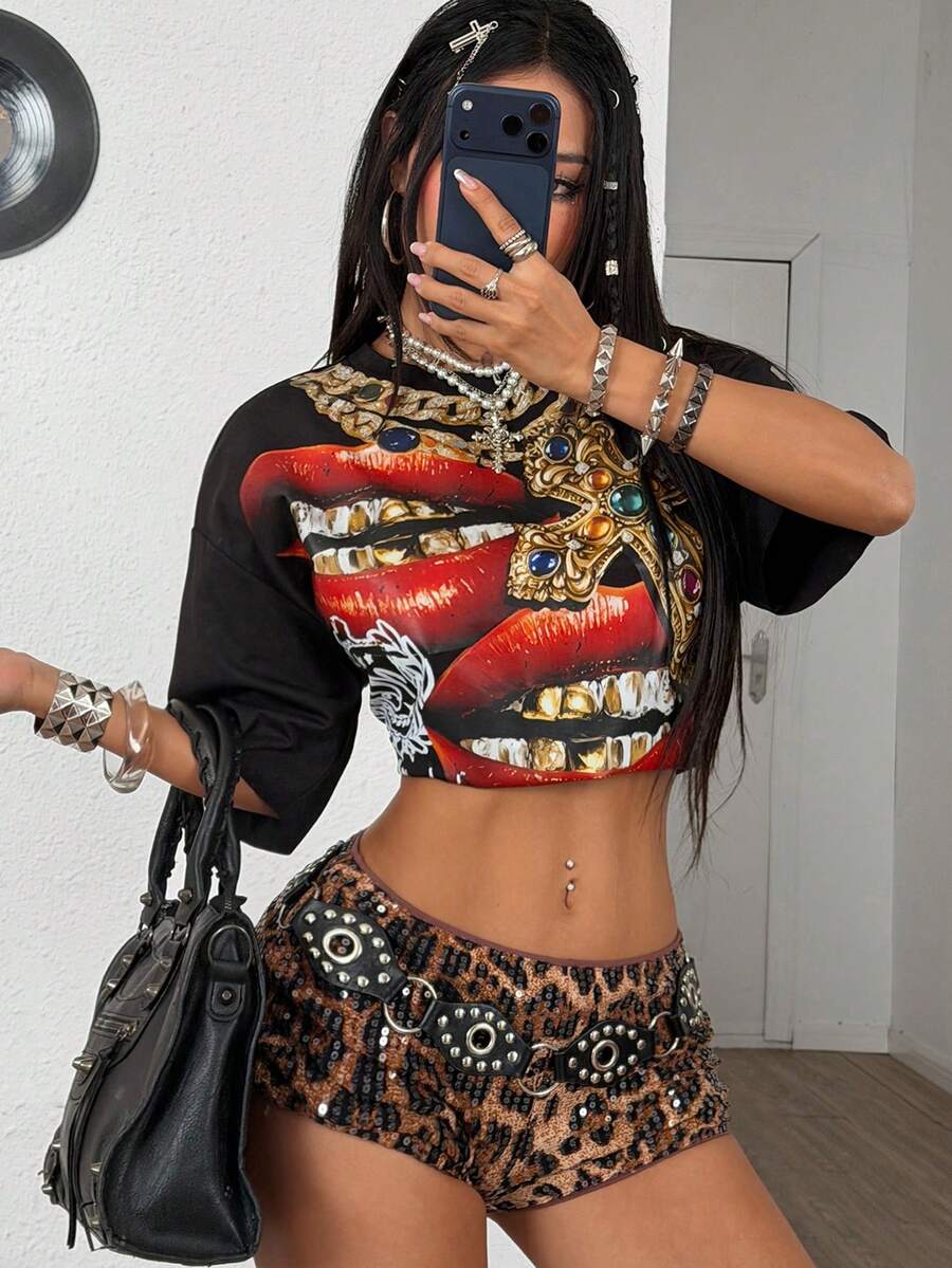 Front view of a women's black oversized crop t-shirt with pink lips graphic, round neckline, and short drop-shoulder sleeves.