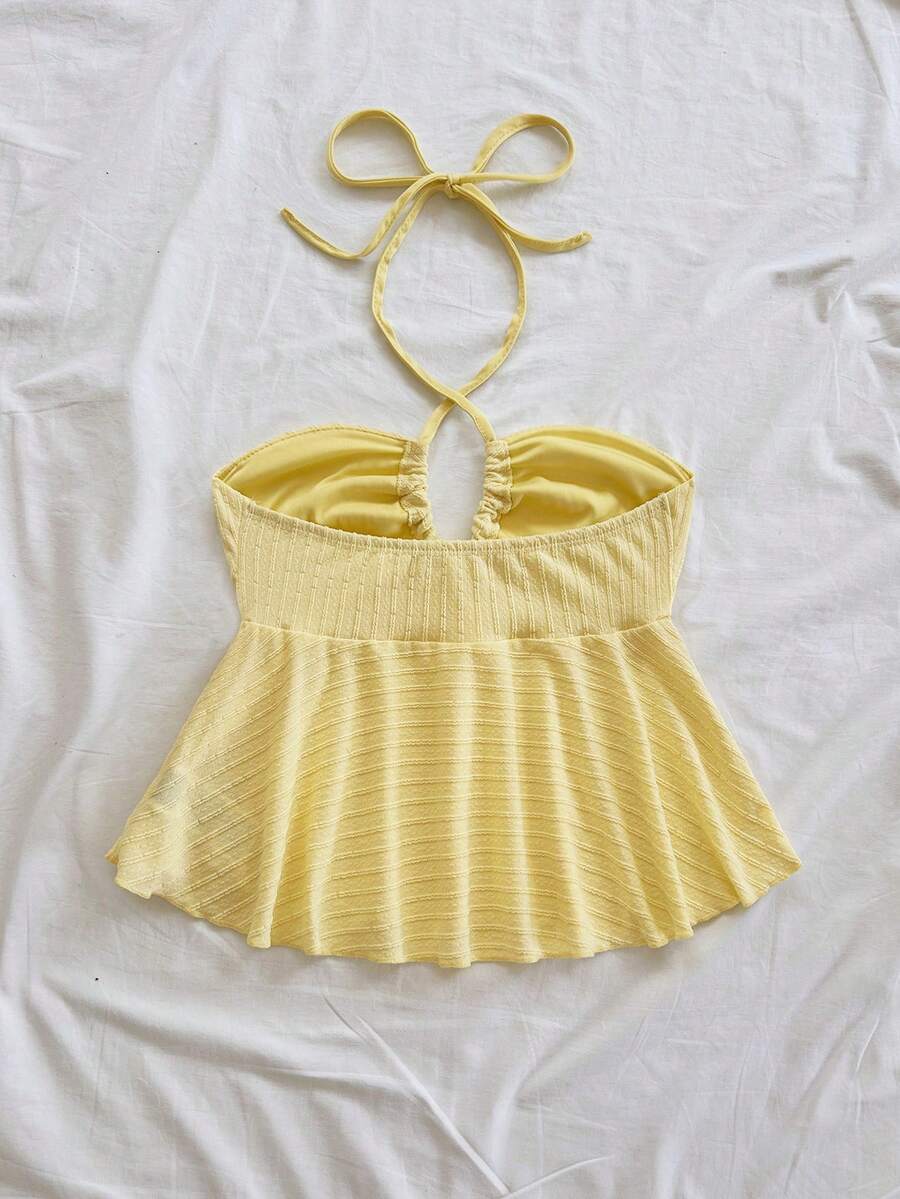 Women's textured V-neck halter tank top with backless knot detail, ruffle hem, and flared silhouette for casual beach and vacation wear.