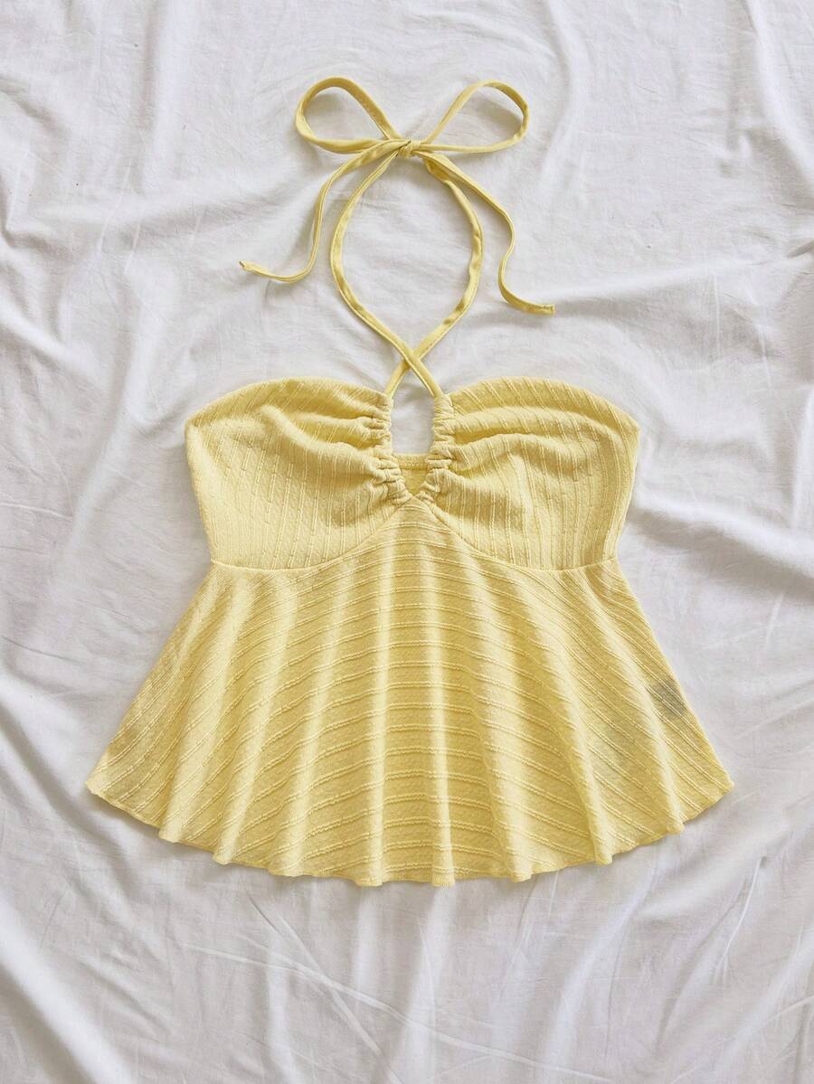 Women's textured V-neck halter tank top with backless knot detail, ruffle hem, and flared silhouette for casual beach and vacation wear.