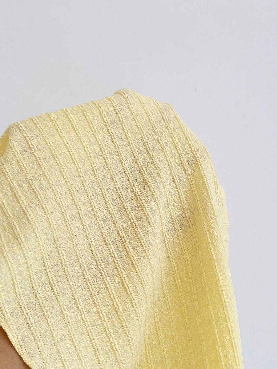 Women's textured V-neck halter tank top with backless knot detail, ruffle hem, and flared silhouette for casual beach and vacation wear.