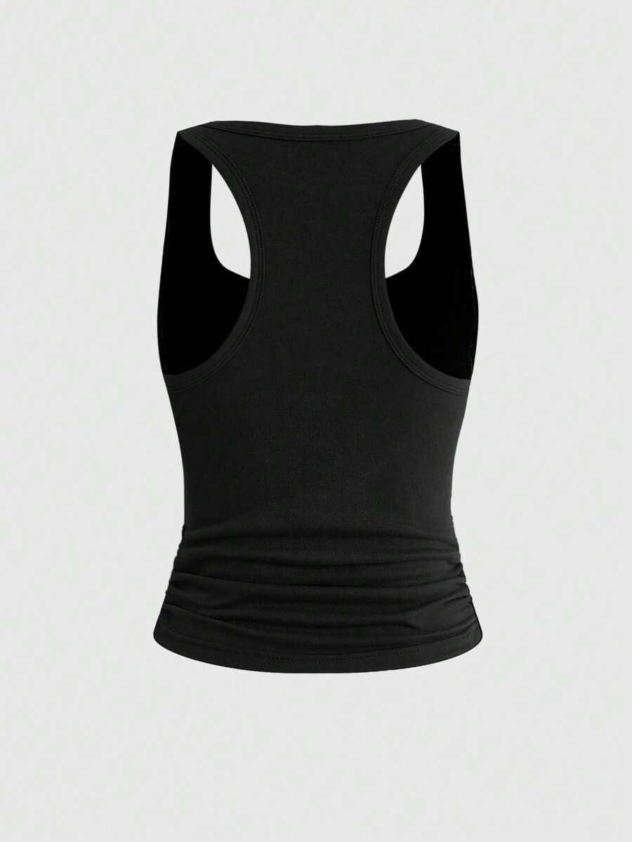 Punk-inspired two-piece set with a fitted scoop neck slogan tank top featuring cross and rhinestone details paired with ultra low waist mini shorts.