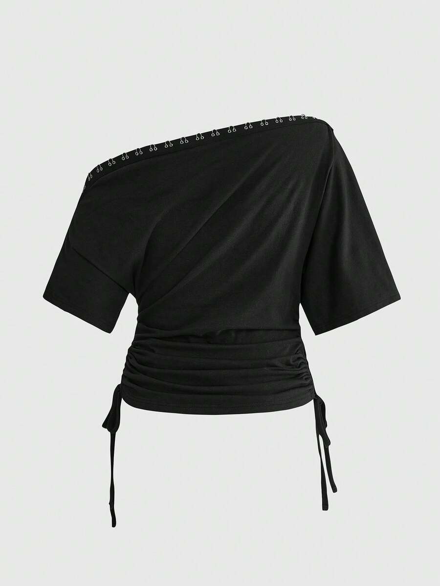 Women's slim fit short sleeve t-shirt featuring an asymmetric off-the-shoulder neckline, ruched design, and metal buckle detail.