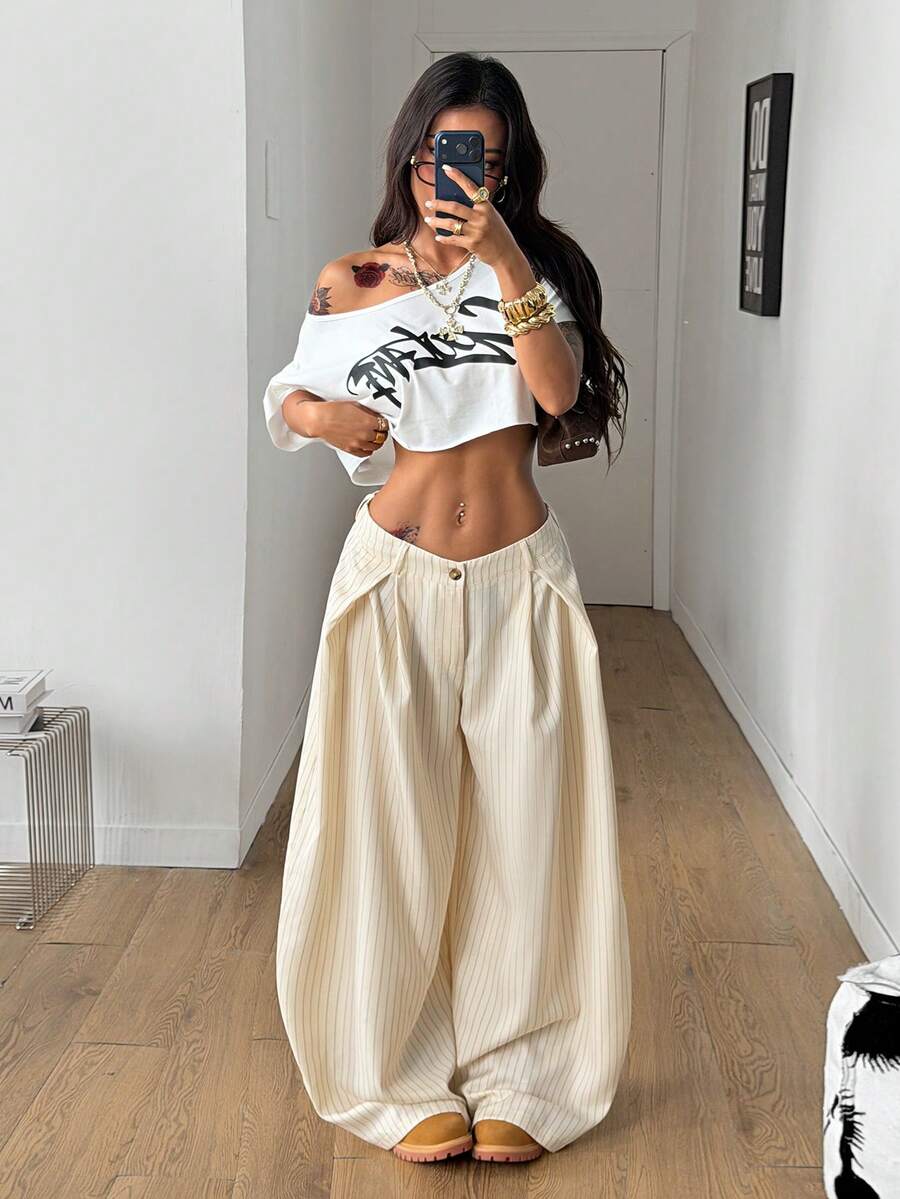 Women's brown striped wide leg pants with a low waist, curved hem, and loose casual fit in woven fabric.