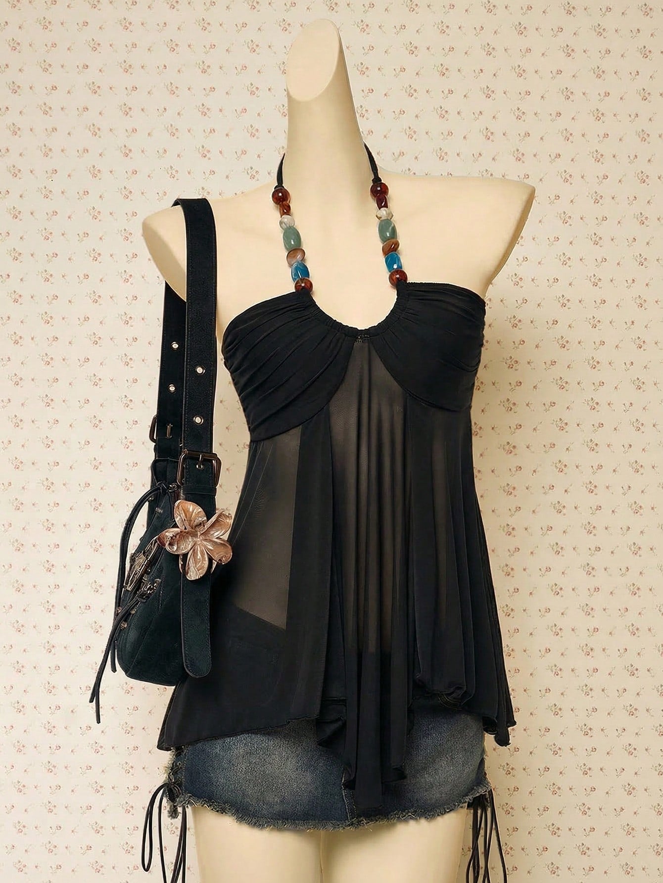 Women's boho halter mesh tank top with asymmetrical hem, semi-sheer finish, lined body, slim fit, and cold shoulder styling.