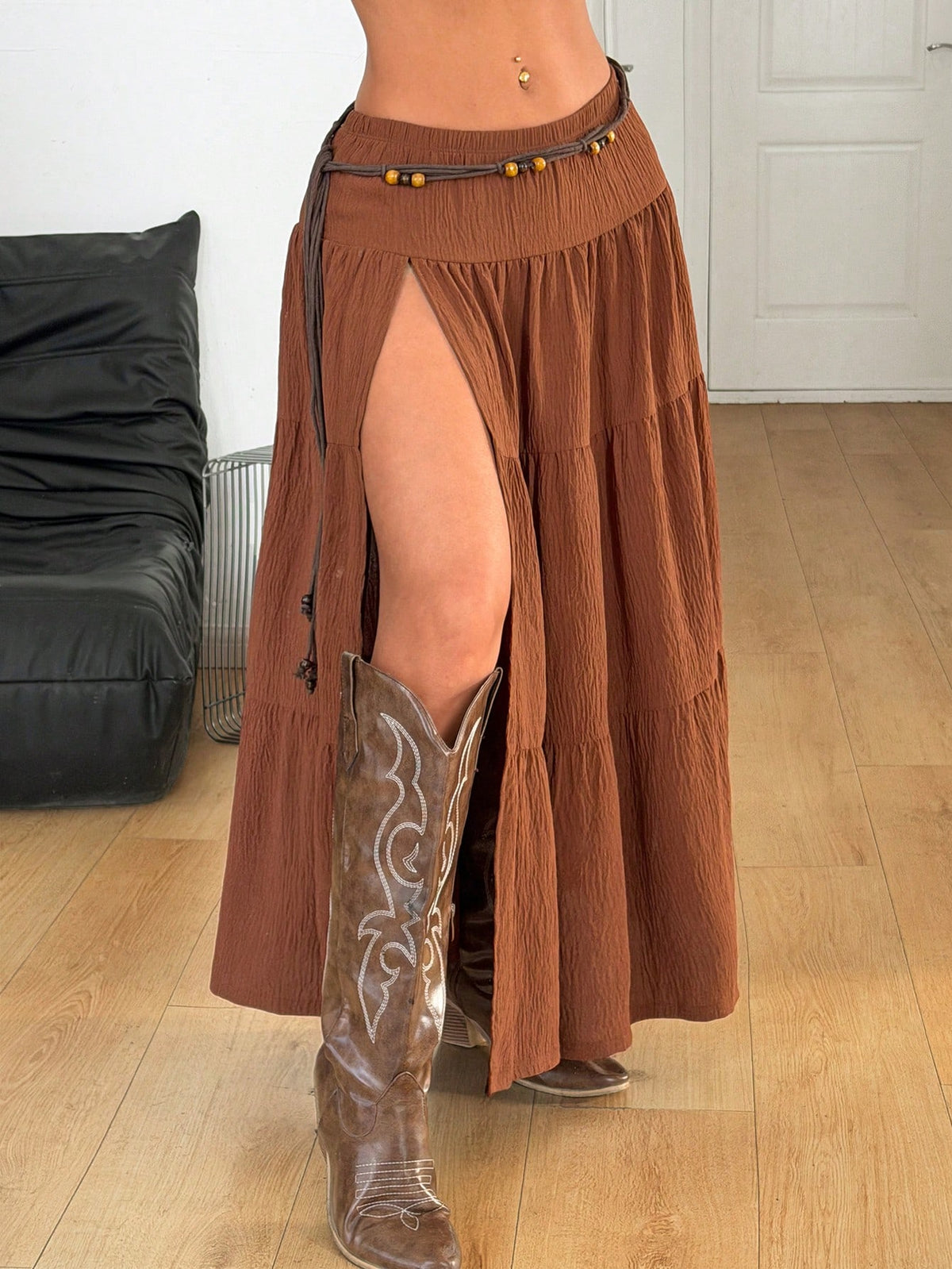 Women's red plaid long skirt featuring a low-rise waist and a side slit in lightweight woven fabric.