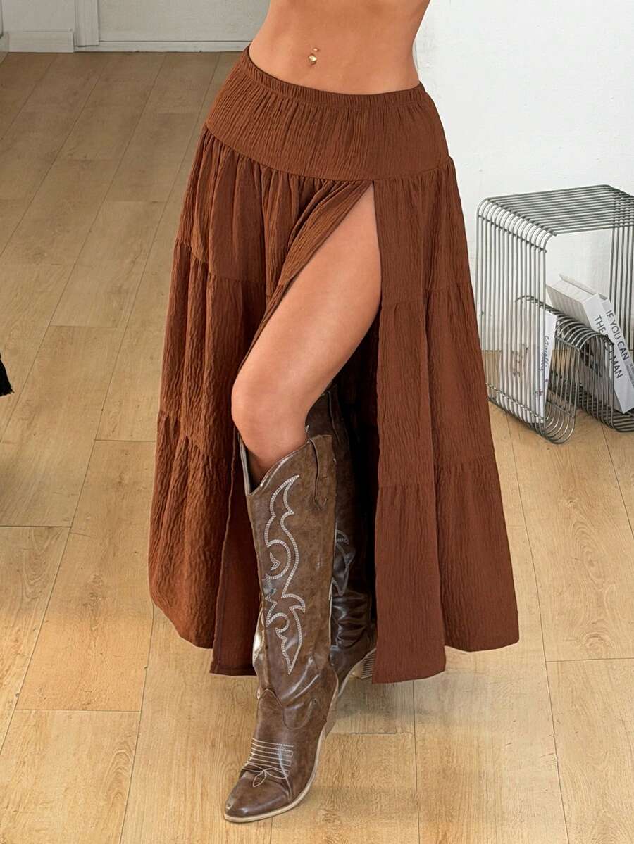 Women's red plaid long skirt featuring a low-rise waist and a side slit in lightweight woven fabric.