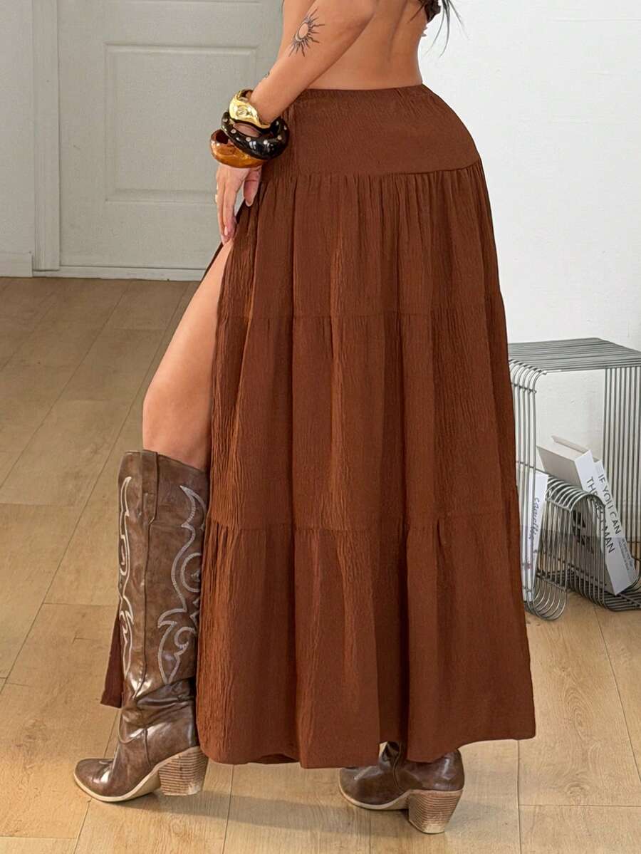 Women's red plaid long skirt featuring a low-rise waist and a side slit in lightweight woven fabric.