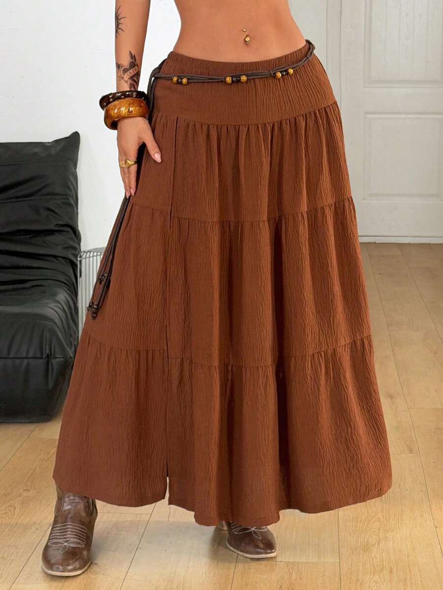 Women's red plaid long skirt featuring a low-rise waist and a side slit in lightweight woven fabric.