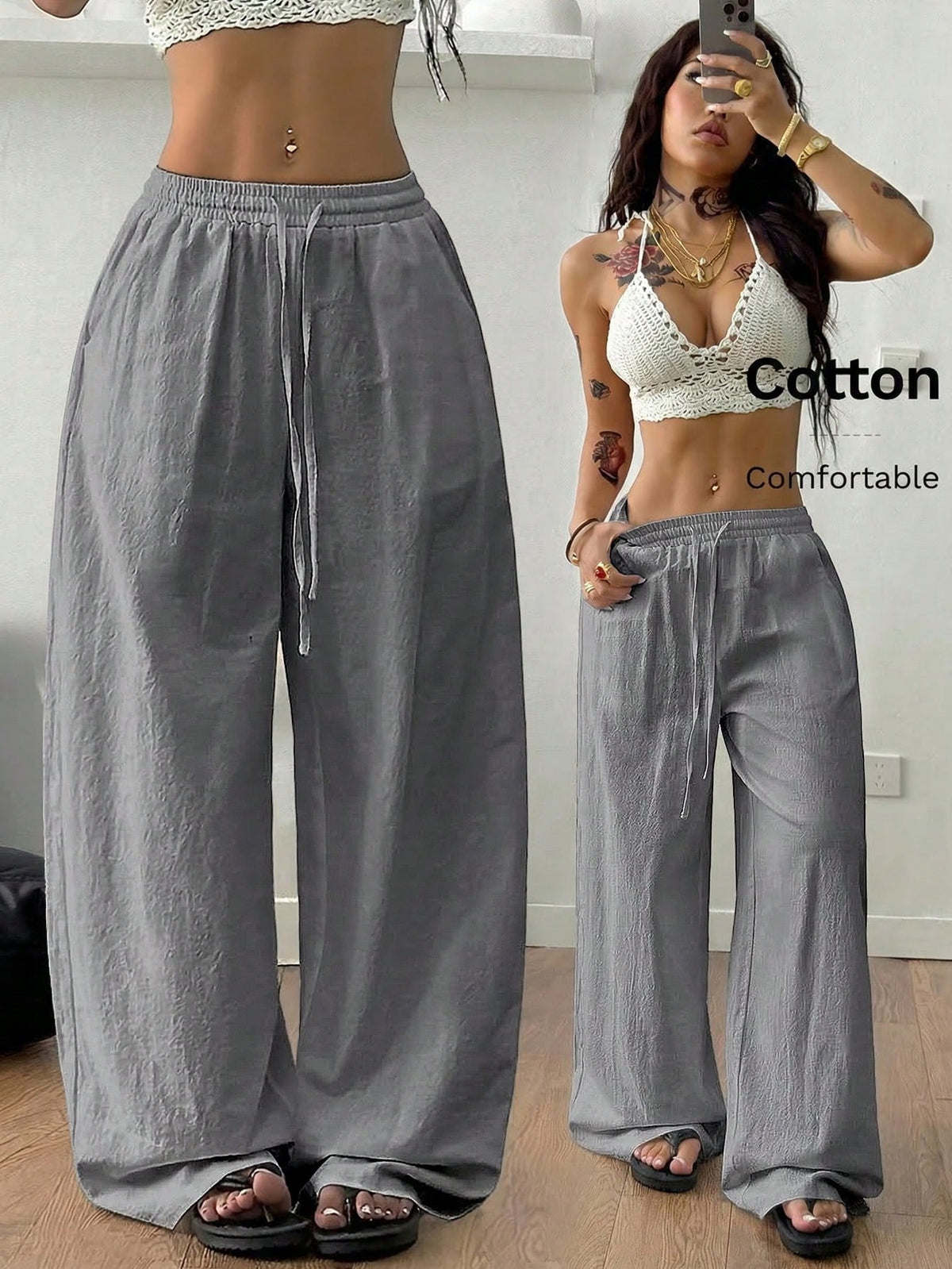 Women's black and white striped wide leg pants featuring an adjustable drawstring waist and side pockets.