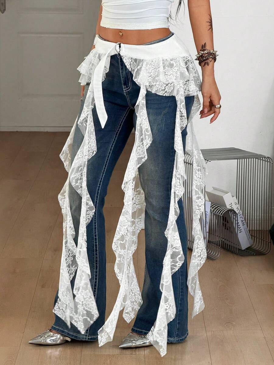 Women's black semi-sheer lace asymmetrical skirt with fringe details, contrast lace, low waist, and ruffle hem for beach, party, concert, or festival outfits.