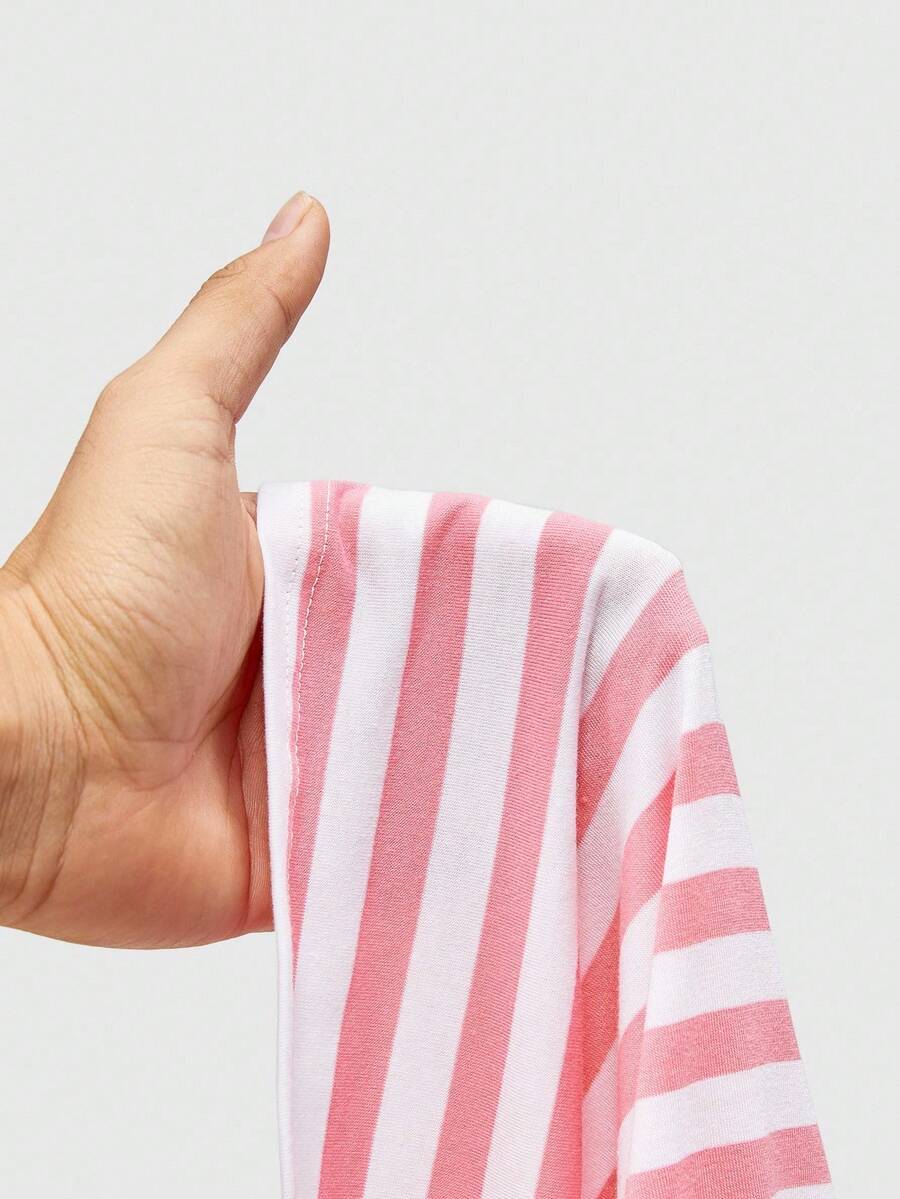 Women's striped strapless tube top featuring ruched detailing, flared hem, and stretchy knit fabric.