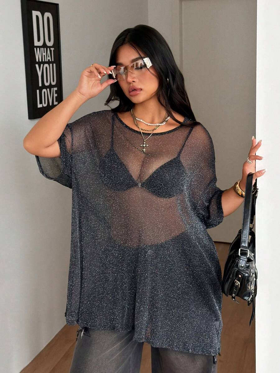 Women's plus size black sheer mesh top featuring a loose fit, round neck, and drop shoulder half sleeves.