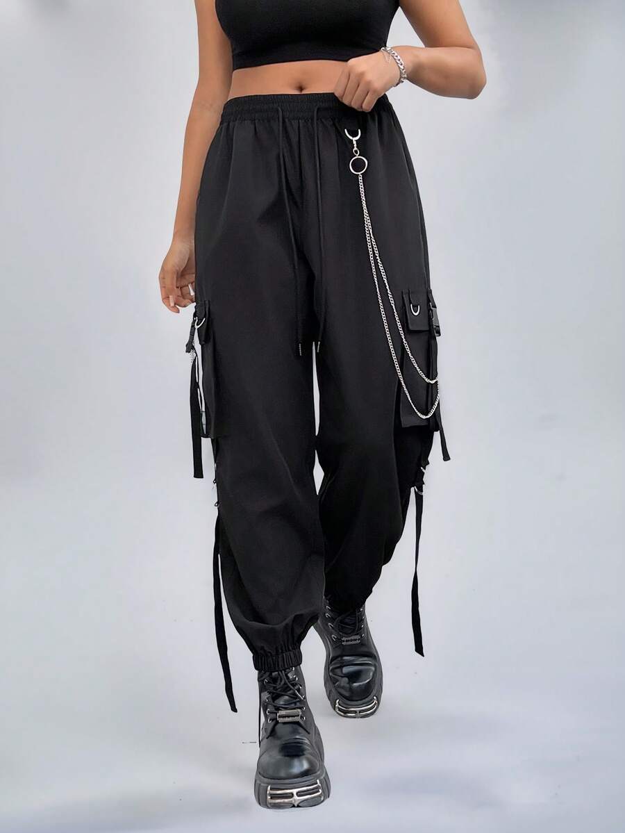 Black plus size cargo pants with drawstring waist and chain accent on loose-fit woven fabric.