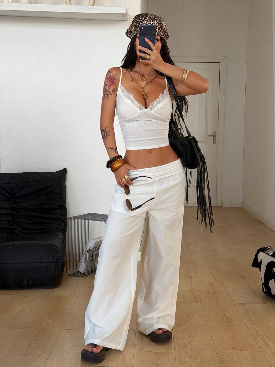 Slim fit cropped camisole top for women featuring contrast lace trim, ruched cup detailing, and delicate spaghetti straps.