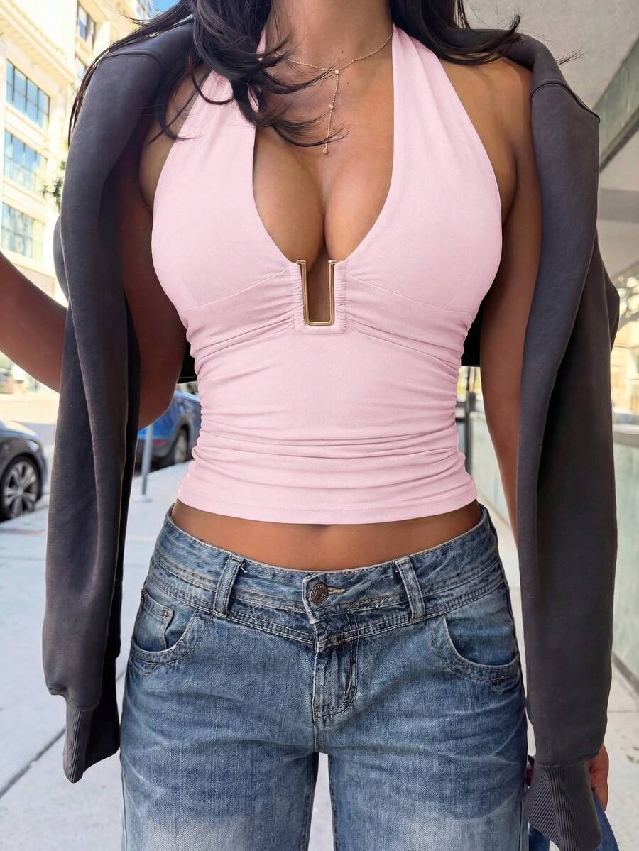Women's backless halter top featuring a knot detail, slim fit silhouette, and long length knitted fabric.