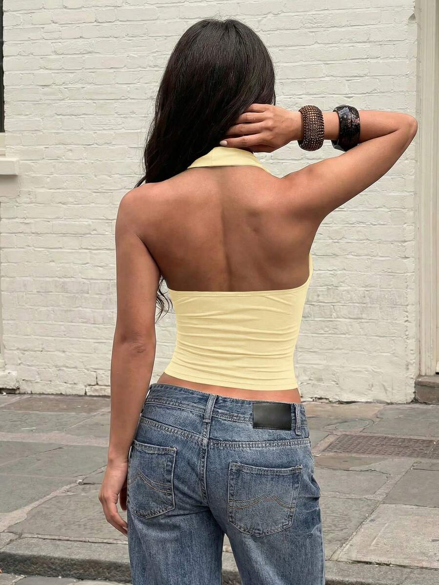 Women's backless halter top featuring a knot detail, slim fit silhouette, and long length knitted fabric.