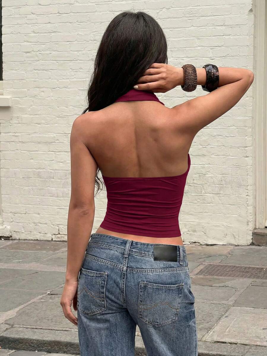 Women's backless halter top featuring a knot detail, slim fit silhouette, and long length knitted fabric.