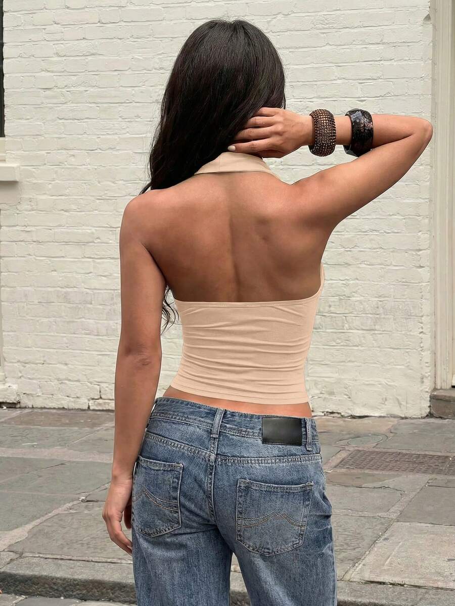 Women's backless halter top featuring a knot detail, slim fit silhouette, and long length knitted fabric.