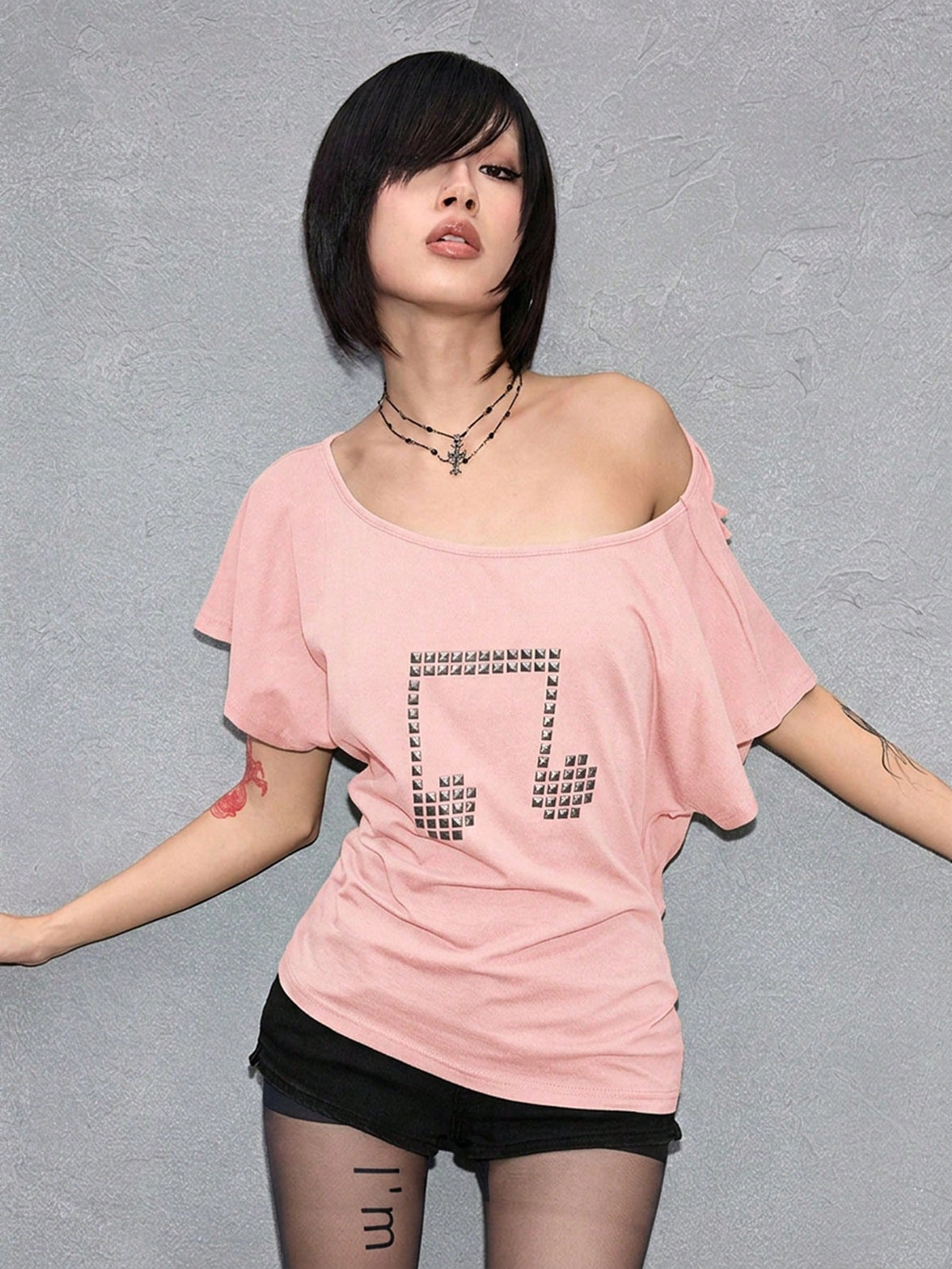 Women's grunge punk style short sleeve t-shirt featuring an asymmetrical neckline, hollow-out cut detail, and relaxed batwing sleeves in a soft cotton stretch fabric.