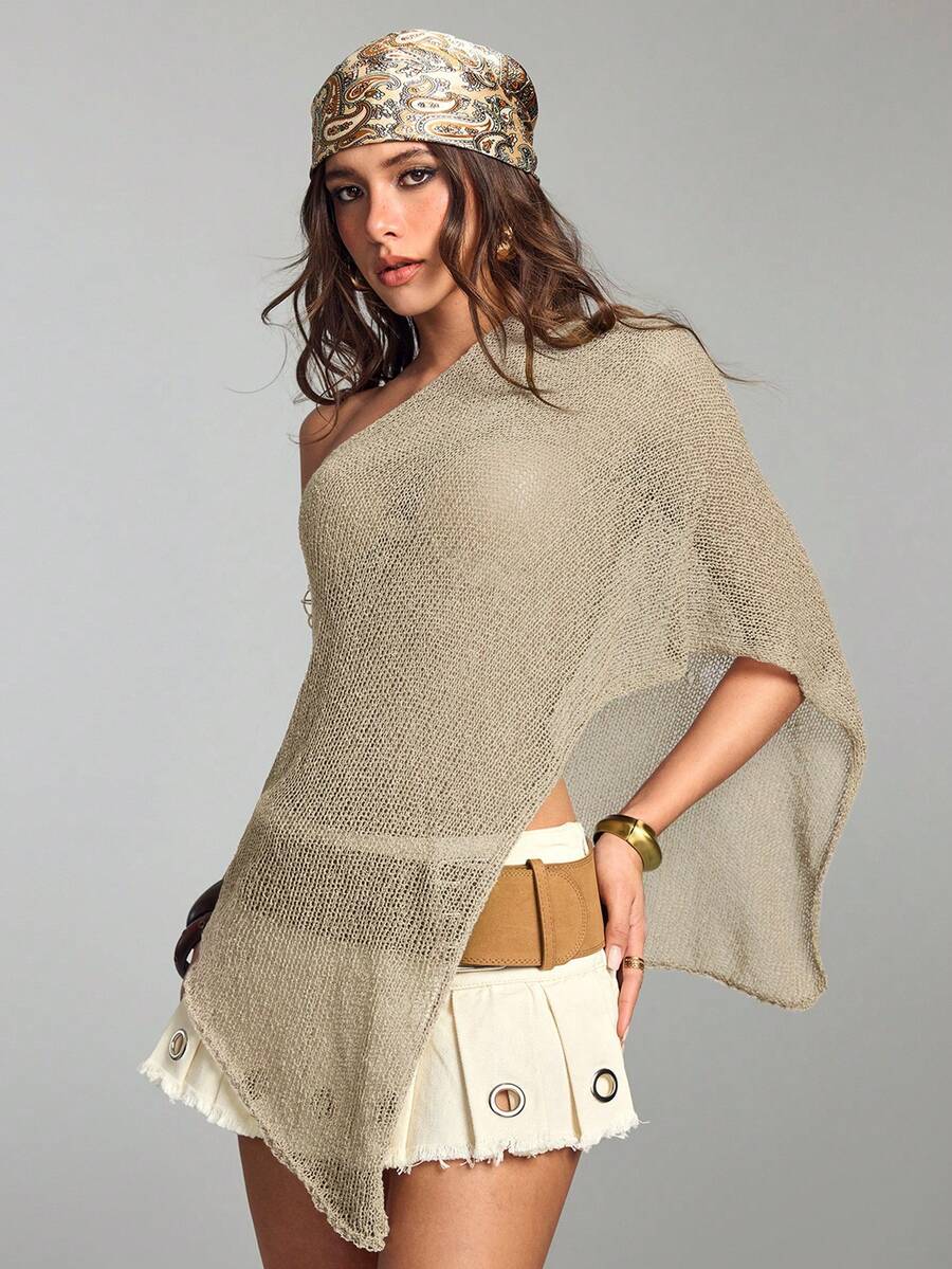 Women's casual hollow knit poncho top with boat neck, cloak sleeves, and asymmetrical hem