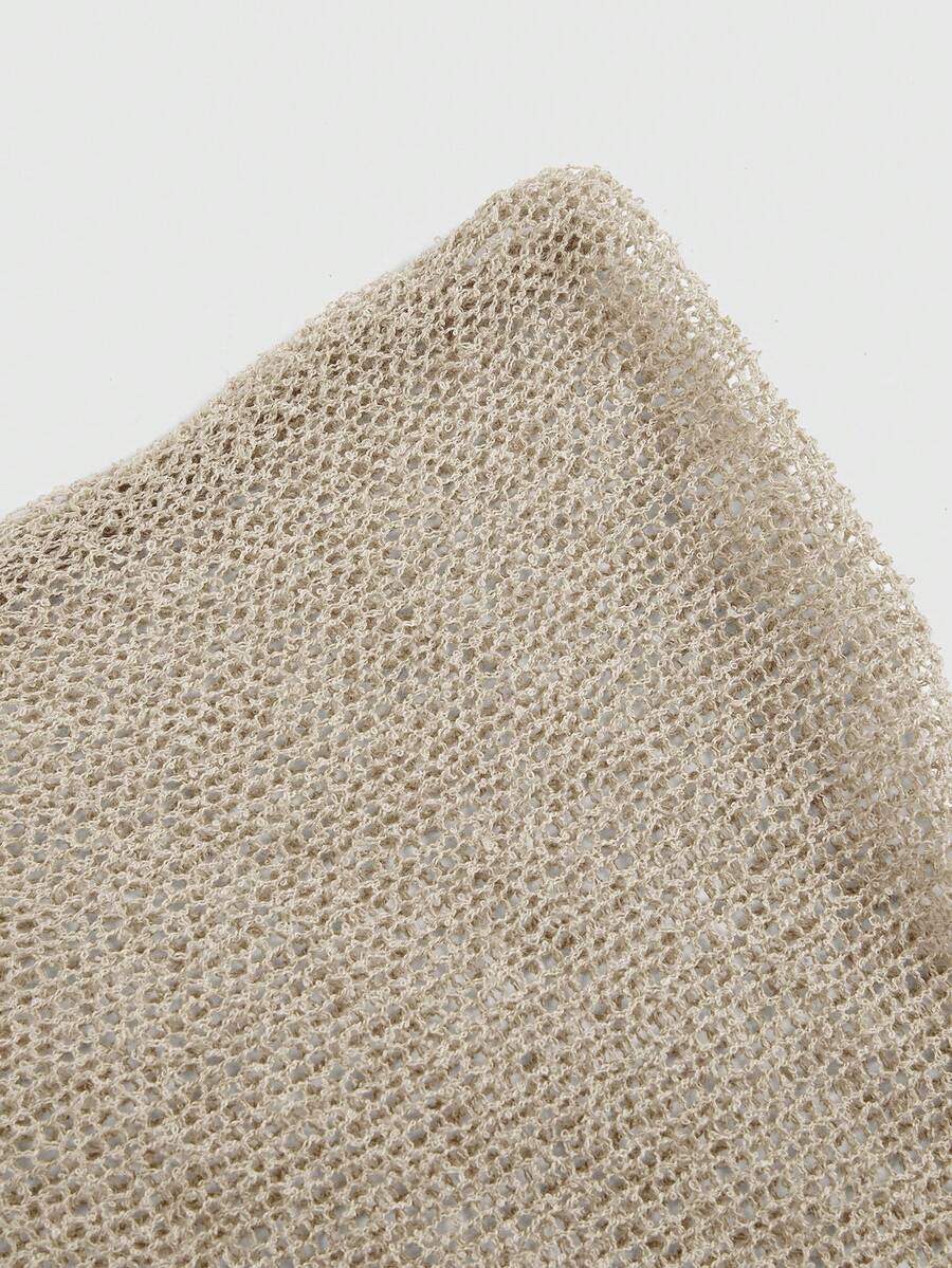 Women's casual hollow knit poncho top with boat neck, cloak sleeves, and asymmetrical hem