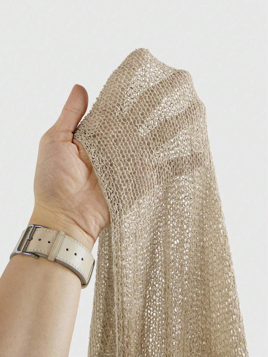 Women's casual hollow knit poncho top with boat neck, cloak sleeves, and asymmetrical hem