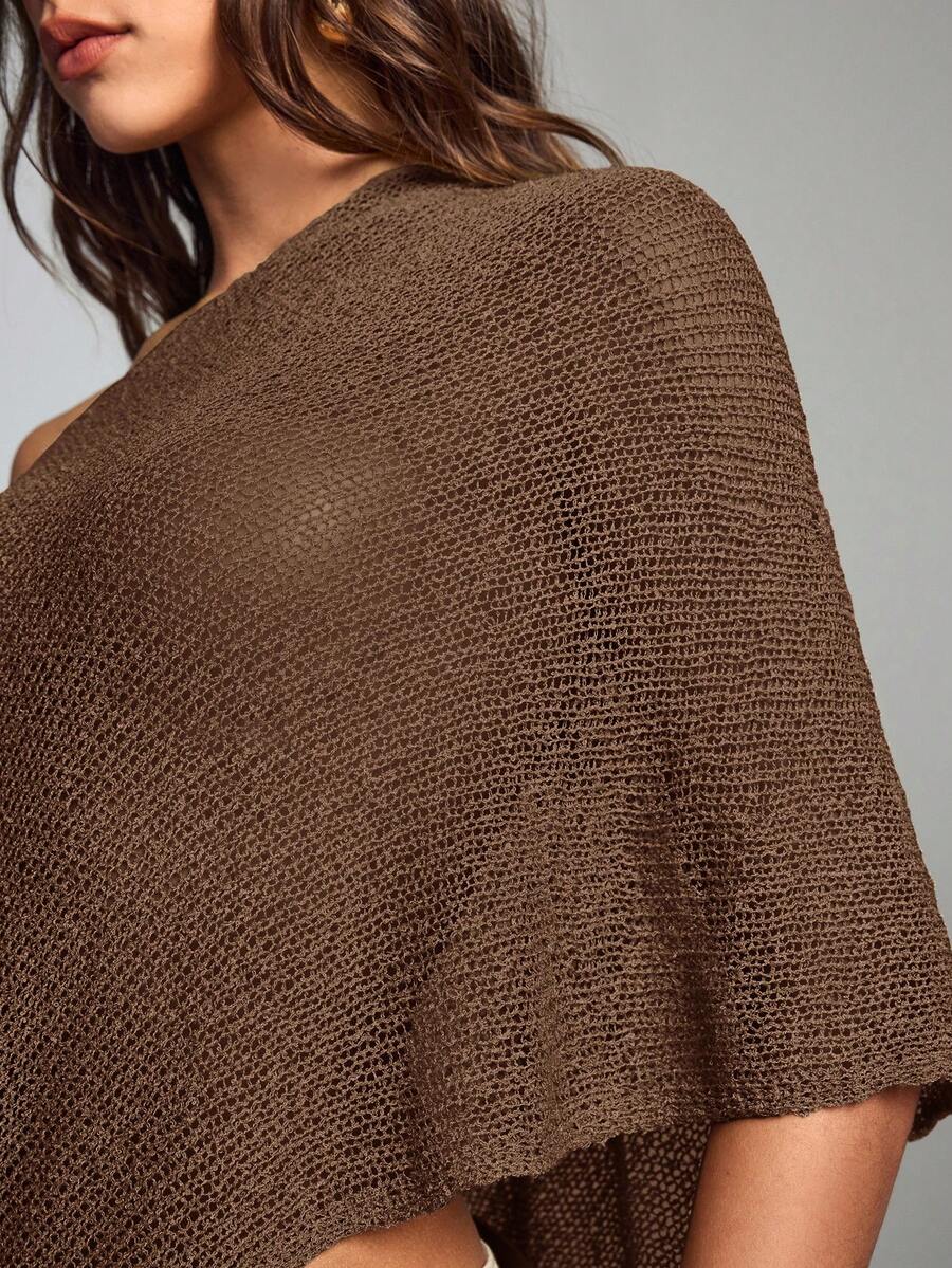 Women's casual hollow knit poncho top with boat neck, cloak sleeves, and asymmetrical hem