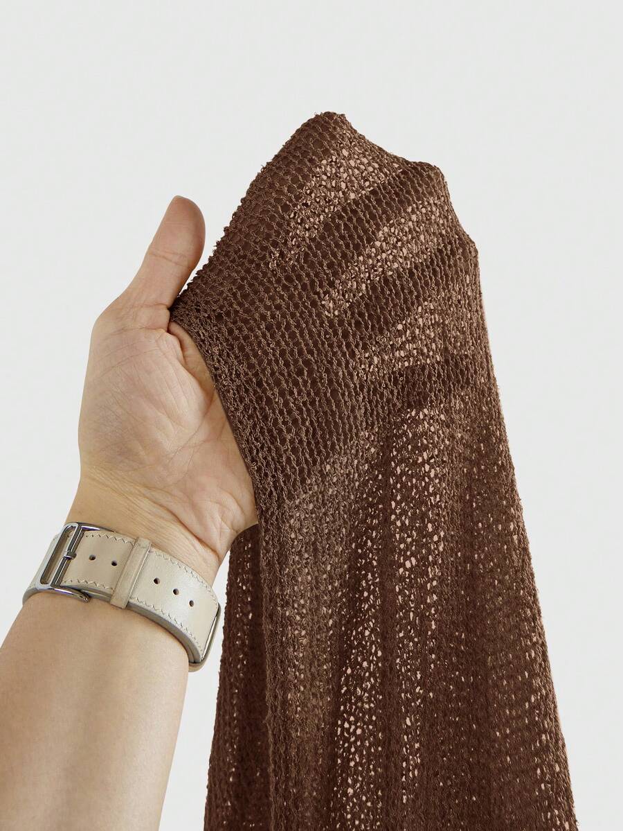 Women's casual hollow knit poncho top with boat neck, cloak sleeves, and asymmetrical hem