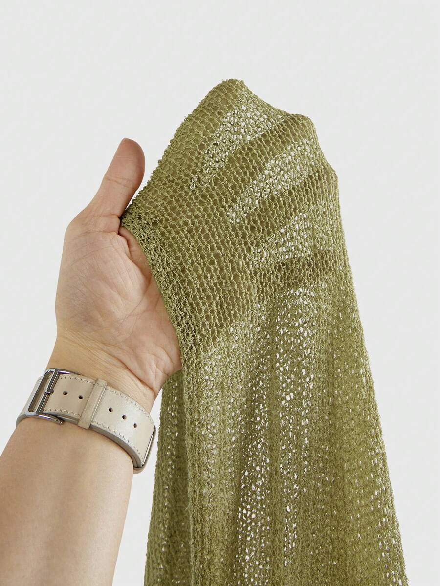 Women's casual hollow knit poncho top with boat neck, cloak sleeves, and asymmetrical hem