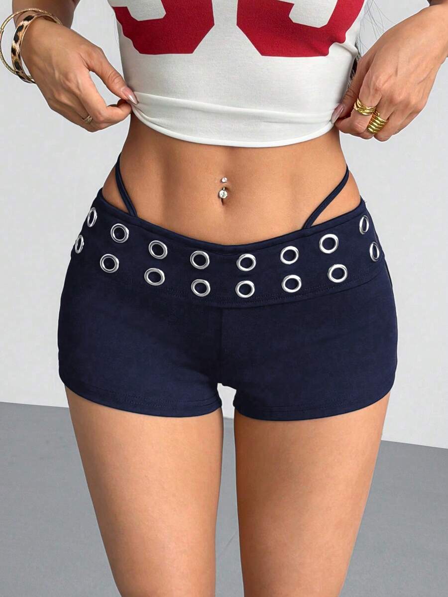 Women's casual track shorts with elastic waist, low-rise mini length, colorblock graphic pattern, and cut-out studded grommet eyelet details.