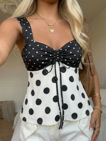 Women's polka dot camisole tank top with strap neckline, bow detail, drawstring style, slim fit, and asymmetrical hem