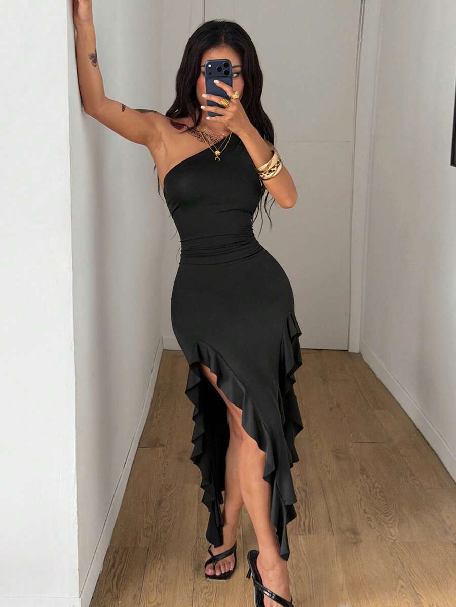 Women's black asymmetrical neck bodycon long dress featuring ruffle accents and a high split thigh in high-stretch knit fabric.