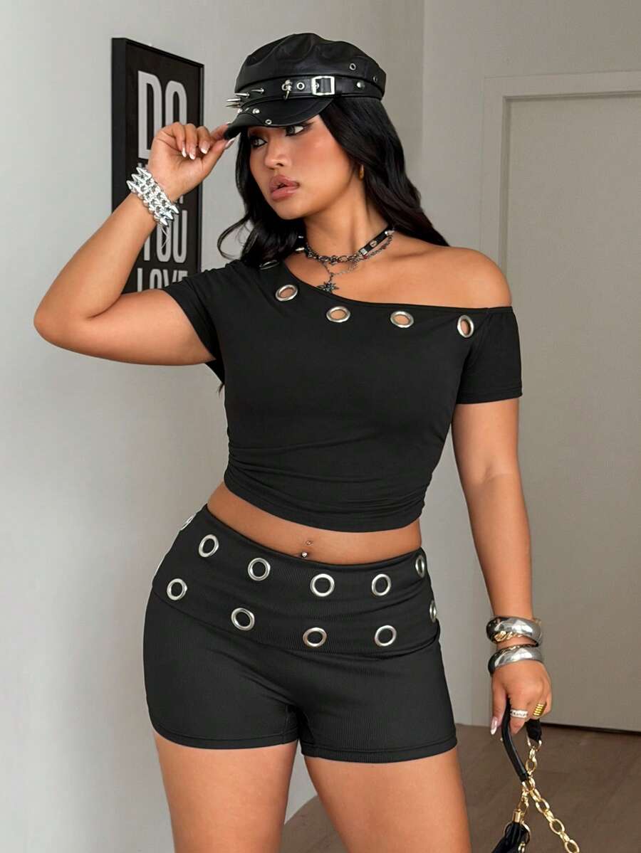 Women's black studded mini shorts crafted from stretch knitted fabric featuring an elastic waistband and skinny fit.