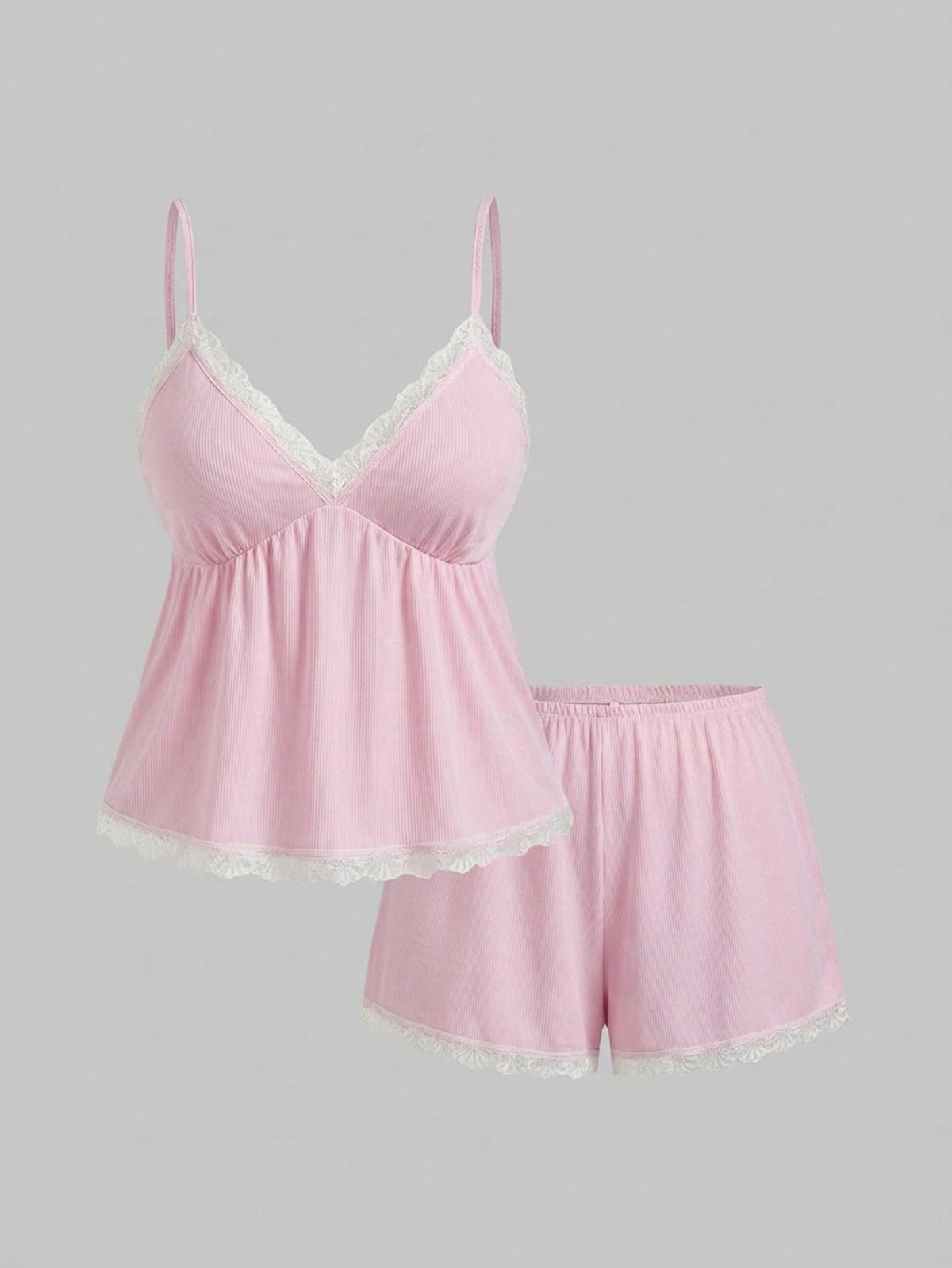 Two-piece ribbed pajama set featuring a lace-trimmed crop camisole top with spaghetti straps and matching shorts.