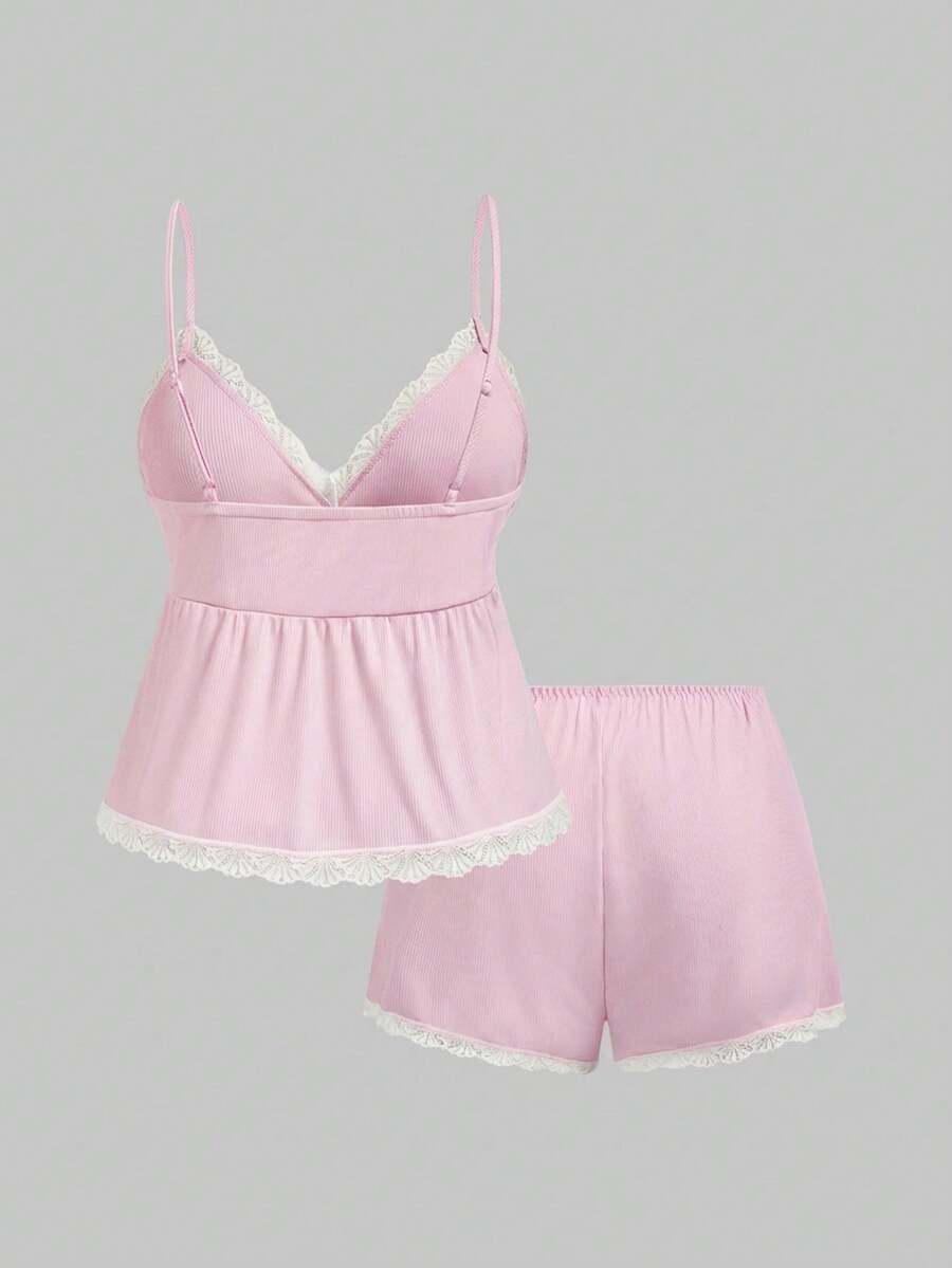 Two-piece ribbed pajama set featuring a lace-trimmed crop camisole top with spaghetti straps and matching shorts.