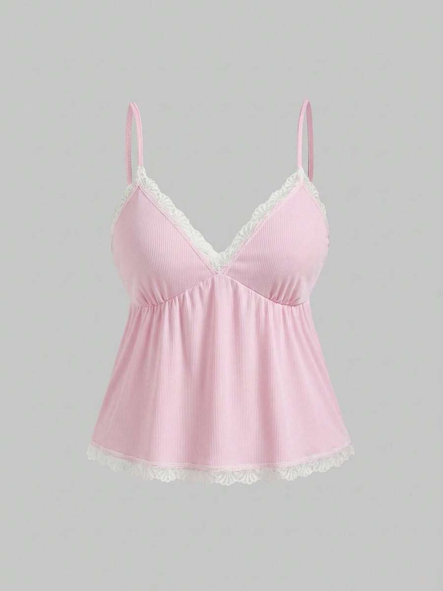 Two-piece ribbed pajama set featuring a lace-trimmed crop camisole top with spaghetti straps and matching shorts.