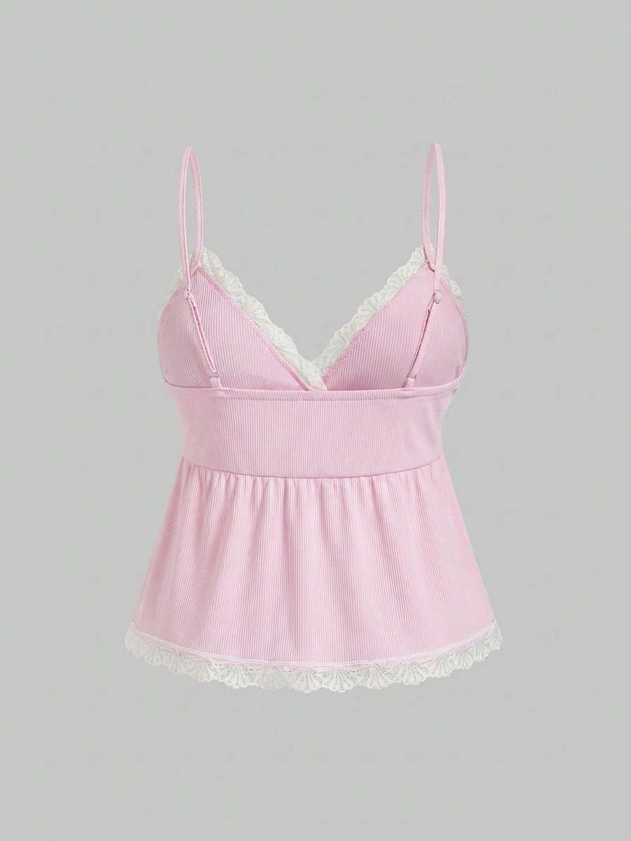 Two-piece ribbed pajama set featuring a lace-trimmed crop camisole top with spaghetti straps and matching shorts.