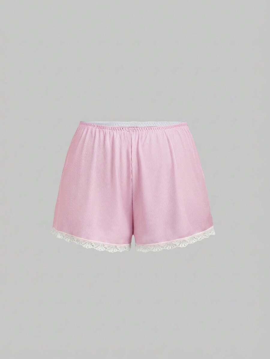 Two-piece ribbed pajama set featuring a lace-trimmed crop camisole top with spaghetti straps and matching shorts.